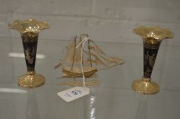 A silver filigree model of a sailing boat and a pair of Niello silver bud vases.
