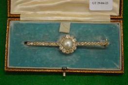 A bar brooch, the central target form set with a pearl surrounded by diamonds with further