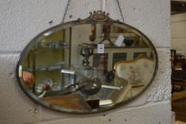 An oval wall mirror.