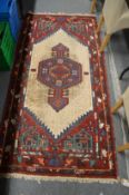 A Persian rug with geometric panels 200cm x 94cm.