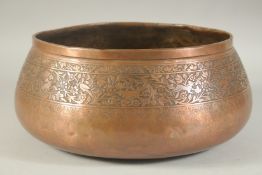A LARGE 19TH CENTURY QAJAR ENGRAVED COPPER BOWL, with a band of animals and flora, 31cm diameter.