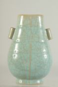 A CHINESE CELADON GUAN-TYPE VASE, with twin handles and character mark to base, 22cm high.