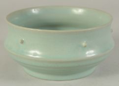 A GOOD CHINESE CELADON BOWL, the exterior with raised bosses and ribbed section beneath, 17cm