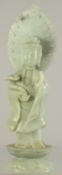 A LARGE CHINESE CARVED JADE BUDDHISTIC FIGURE, holding a ruyi scepter and with halo, 33.5cm high.