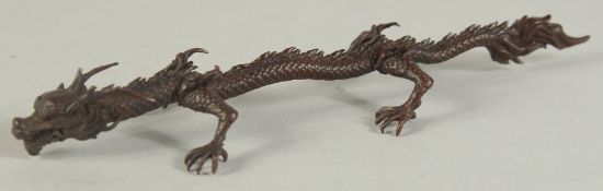A JAPANESE BRONZE OKIMONO OF A DRAGON, character mark to underside, 15.5cm long.