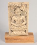 AN 18TH-19TH CENTURY THAI CARVED BONE PANEL, depicting Buddha, mounted to a wooden base, panel 9cm x