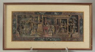 A CHINESE GILT AND LACQUERED CARVED WOOD PANEL, depicting a scene with a dignitary on horseback