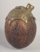A FINE 19TH CENTURY PERSIAN QAJAR CARVED COCONUT HUQQA BASE, with engraved and chased brass mount,