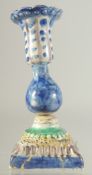 AN ISLAMIC GLAZED POTTERY CANDLESTICK, 16.5cm high.