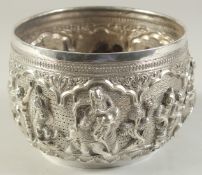 A 19TH CENTURY BURMESE SILVER BOWL, with fine repose figural decoration, 16cm diameter.