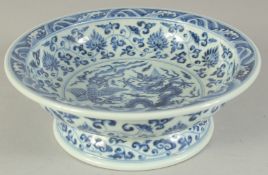 A CHINESE BLUE AND WHITE PORCELAIN BOWL, the centre painted with dragon and phoenix, the base with