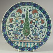 A 19TH CENTURY KUTAHYA GLAZED POTTERY PLATE, painted with sprays of flora, 29.5cm diameter.