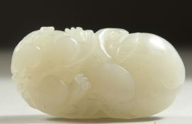 A 19TH CENTURY CHINESE JADE CARVING of a lion dog sat upon a peach, 5.5cm long.