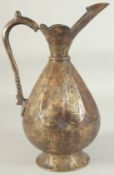 AN ENGRAVED SELJUK STYLE BRASS EWER, with bands of calligraphy, 34.5cm high.
