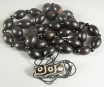 A BLACK WOOD BEADED NECKLACE, together with a Tibetan dsi style bead.