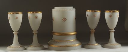 A SET OF ISLAMIC MARKET OPALINE GLASS, comprising four glasses and one stand, (5 pieces).