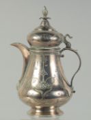 A FINELY ENGRAVED 19TH CENTURY OTTOMAN TURKISH LOW GRADE SILVER COFFEE POT, 18.5cm high.
