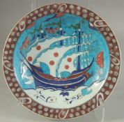 A TURKISH OTTOMAN GLAZED POTTERY PLATE, 31cm diameter.