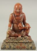 A CHINESE REPUBLIC PERIOD SOAPSTONE LUOHAN FIGURE AND STAND. figure 8cm high.