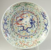 A LARGE CHINESE DOUCAI PORCELAIN CHARGER, (af), 44cm diameter.