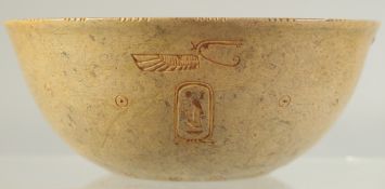 AN UNUSUAL EGYPTIAN STONE BOWL, with fine carvings to the exterior and centre interior, 13.5cm