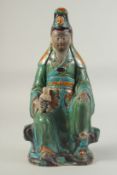 A LARGE CHINESE SANCAI SEATED GUANYIN AND CHILD, possibly Ming, glazed with green, turquoise,