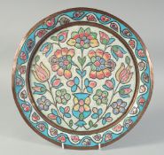 AN OTTOMAN ENAMELLED COPPER PLATE, with central floral spray and foliate border, 33.5cm diameter.
