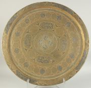 AN ISLAMIC SILVER AND COPPER INLAID BRASS CIRCULAR TRAY, with panels of calligraphy and finely