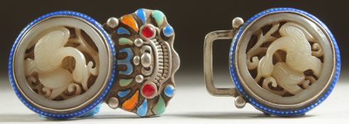 TWO CHINESE CARVED AND PIERCED JADE ROUNDELS, inset with within an enamelled metal belt buckle, each