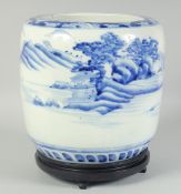 A CHINESE BLUE AND WHITE PORCELAIN JARDINIERE, on a fitted hardwood stand, 28.5cm high overall.