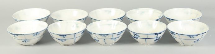 A COLLECTION OF TEN BLUE AND WHITE GLAZED POTTERY BOWLS, with floral motif design, each 17cm