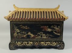 A 19TH CENTURY CHINESE BLACK AND GILT LACQUERED PAGODA CASKET, with roof-formed cover and painted