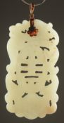A 19TH CENTURY CHINESE CARVED AND PIERCED JADE PENDANT, with central longevity symbol, dragon and