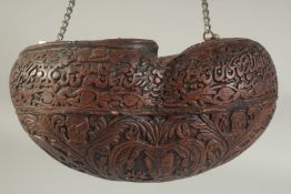 A COCO DE MER KASHKUL, with mounted chain handle, 25cm long.