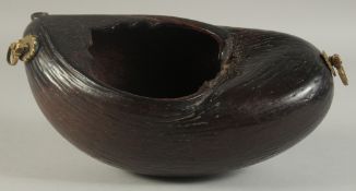 AN EARLY 20TH CENTURY COCO DE MER KASHKUL, with brass mounts for chain, 30cm long.