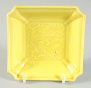 A SMALL CHINESE YELLOW GLAZED SQUARE FORM DRAGON DISH, 9.5cm square.