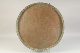 A LARGE ENGRAVED COPPER TRAY, with animals and calligraphy, 56cm diameter.