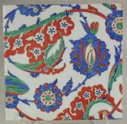 A LARGE IZNIK STYLE GLAZED POTTERY TILE, painted with foliate decoration, 28cm square.