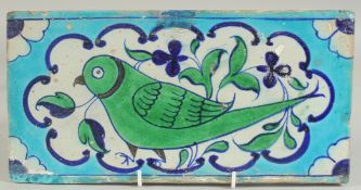 A FINE EARLY 19TH CENTURY NORTH INDIAN MULTAN GLAZED POTTERY TILE, painted with a green parrot, 30.