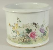 A CHINESE FAMILLE ROSE PORCELAIN BRUSH POT, painted with a cricket and flora, the base with red