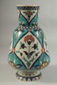 A 19TH CENTURY KUTAHYA GLAZED POTTERY VASE, painted with floral motifs, indistinct signature to