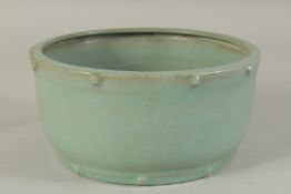 A CHINESE CELADON RU WARE BOWL, the rims with raised bosses, 19cm diameter.