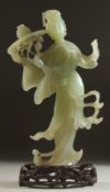 A CHINESE CARVED JADE FIGURE OF GUANYIN on a fitted wooden base, figure 24.5cm high.