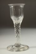 A LARGE 18TH CENTURY ENGLISH GLASS with faceted cut stem. 5.75ins high.