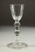 AN 18TH CENTURY ENGLISH WINE GLASS with inverted bowl with two knops to the stem.
