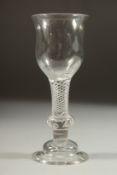 A GOOD 18TH CENTURY ENGLISH WINE GLASS with inverted tulip bowl and air twist stem, with knop.
