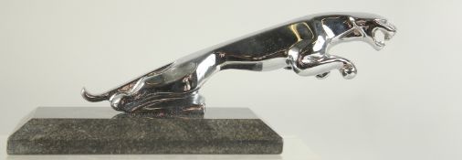 A CHROME JAGUAR CAR MASCOT on a marble base. 6ins long.