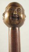 A WALKING STICK WITH FOUR FACES BRASS HANDLE.