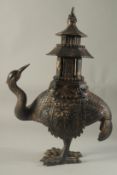 A CHINESE BRONZE EMU CENSER carrying a temple on its back. 16ins high.