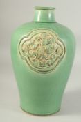 A CHINESE GREEN GLAZE JIZHOU VASE, with two relief floral panels. 29.5cm high.